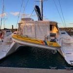 'Mischief' Lightwave 38 Sailing Catamaran Stern Blinds Down with Tender